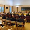 Slide 1: A Parliamentary committee in action at Australian Parliament House. Observers are watching the main discussion.