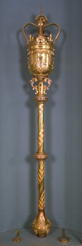 The gold Mace, with its emblems and etchings, on a blue background.