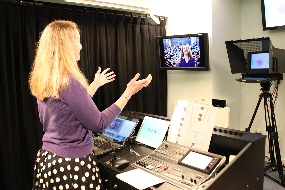 An educator in a video conferencing studio delivering a professional learning program.