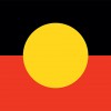 Slide 2: The Australian Aboriginal flag: the upper half black and lower red. A yellow circle sits in the centre. 